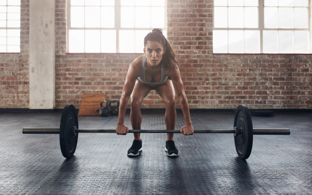 Female Endurance athlete lifting barbell