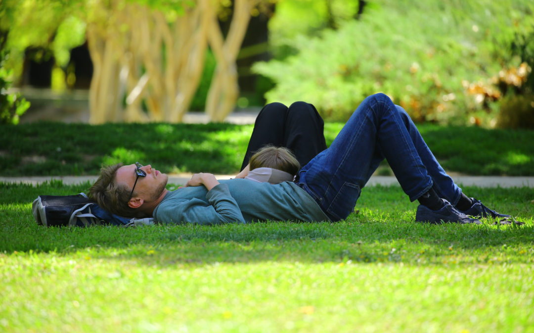 Man sleeping on the grass with girlfriend