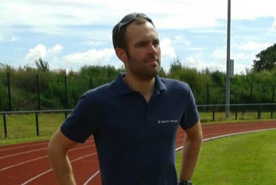 Profile photo of Joe Brocklehurst standing on a running track